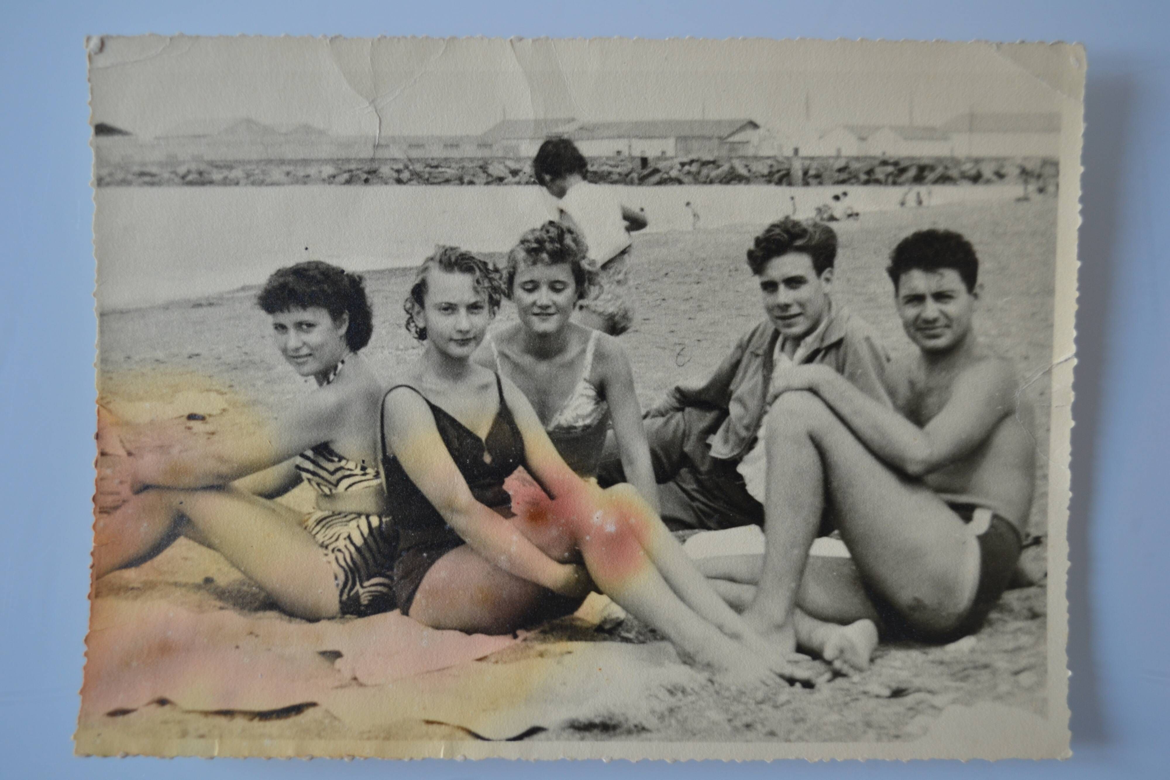 Old film photo circa 1950 the beach group of teenagers