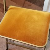 Two gold velvet folding chairs