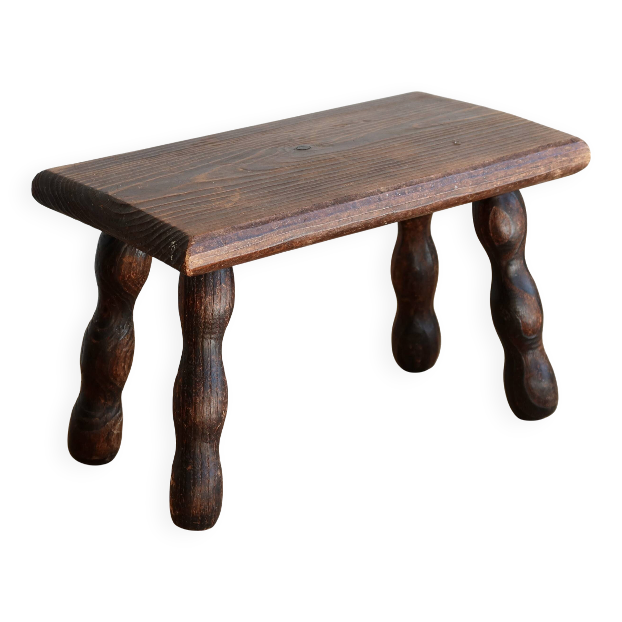 Vintage rectangular stool in dark wood with turned legs.
