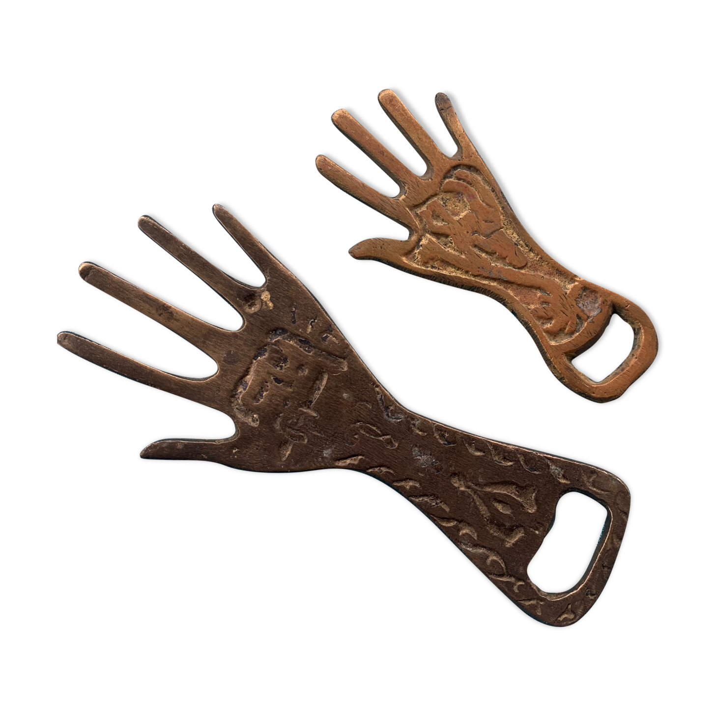 Two brass bottle openers in the shape of a chiseled hand vintage oriental décor