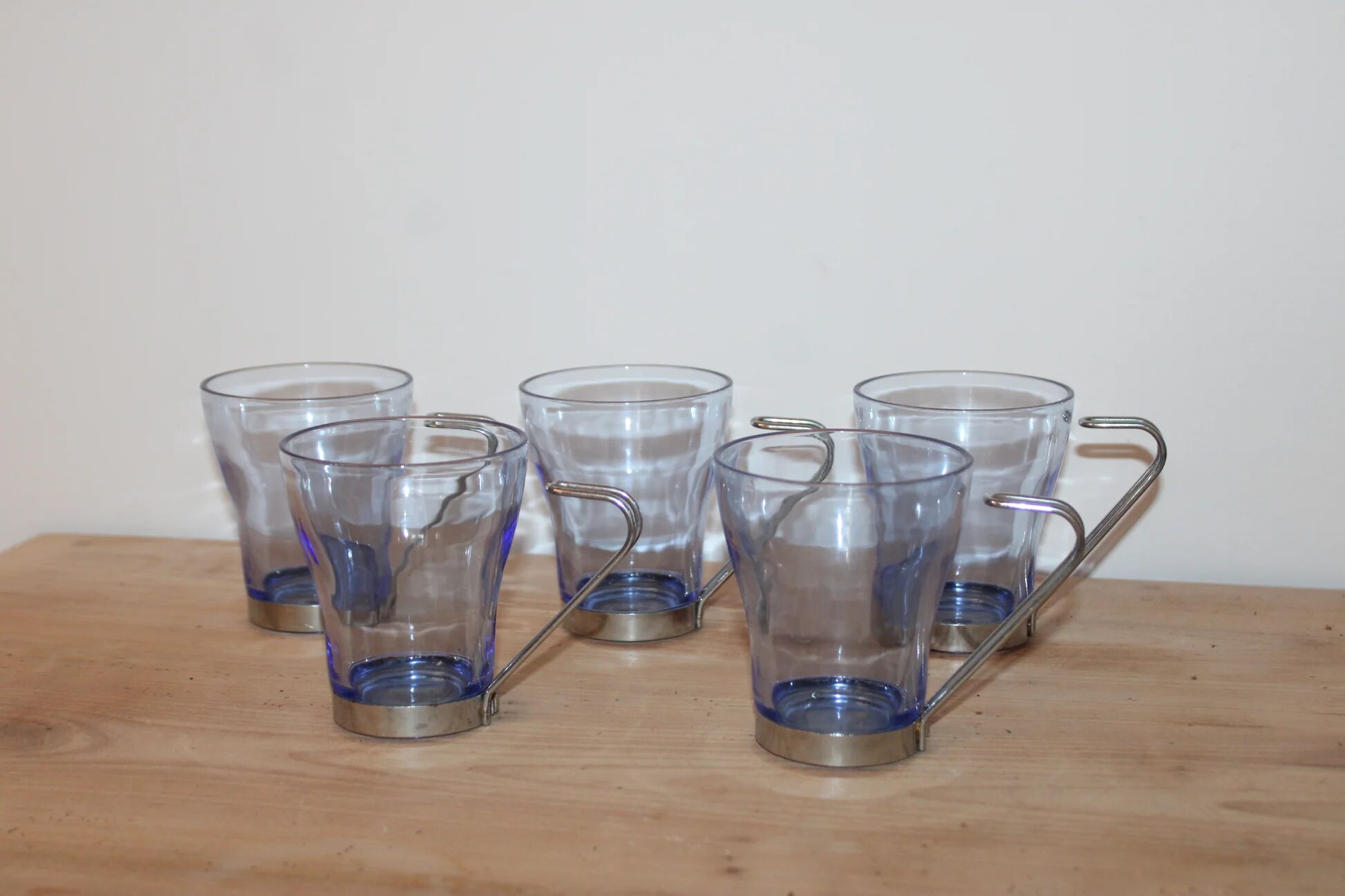 Set of 5 vintage blue-tinted glass cups with metal holders.