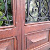 Porte d’entrée vitrée en chêne et grilles en fer, XIXème s.