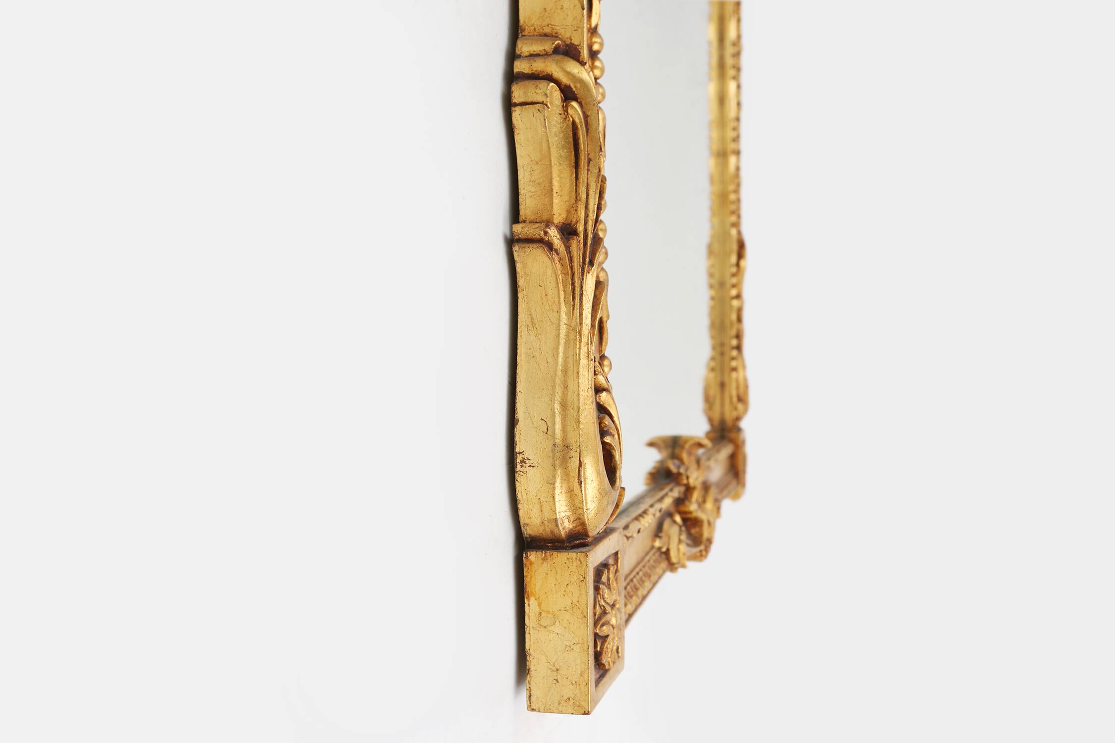 Highly decorated gilted carved wooden wall mirror, Belgium ca. 1950