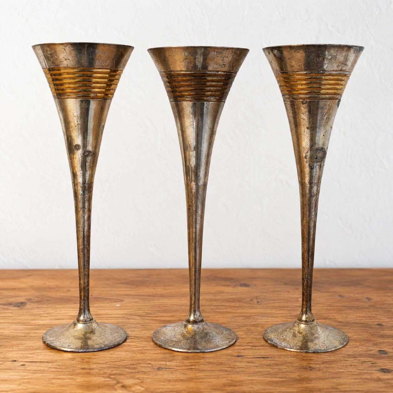 Set of 3 vintage silver-plated and gold footed cups.
