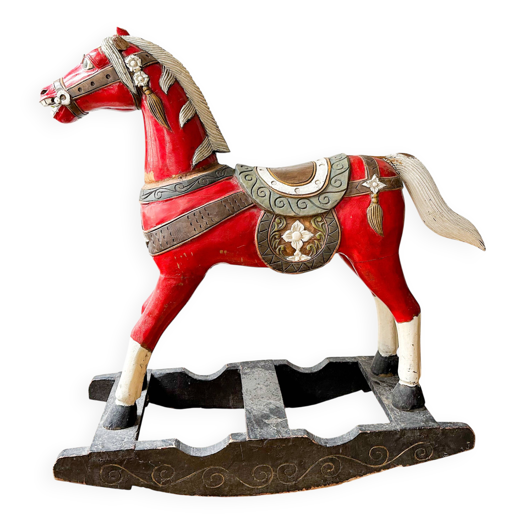 Large decorative rocking horse made of carved and hand-painted wood.