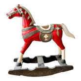 Large decorative rocking horse made of carved and hand-painted wood.