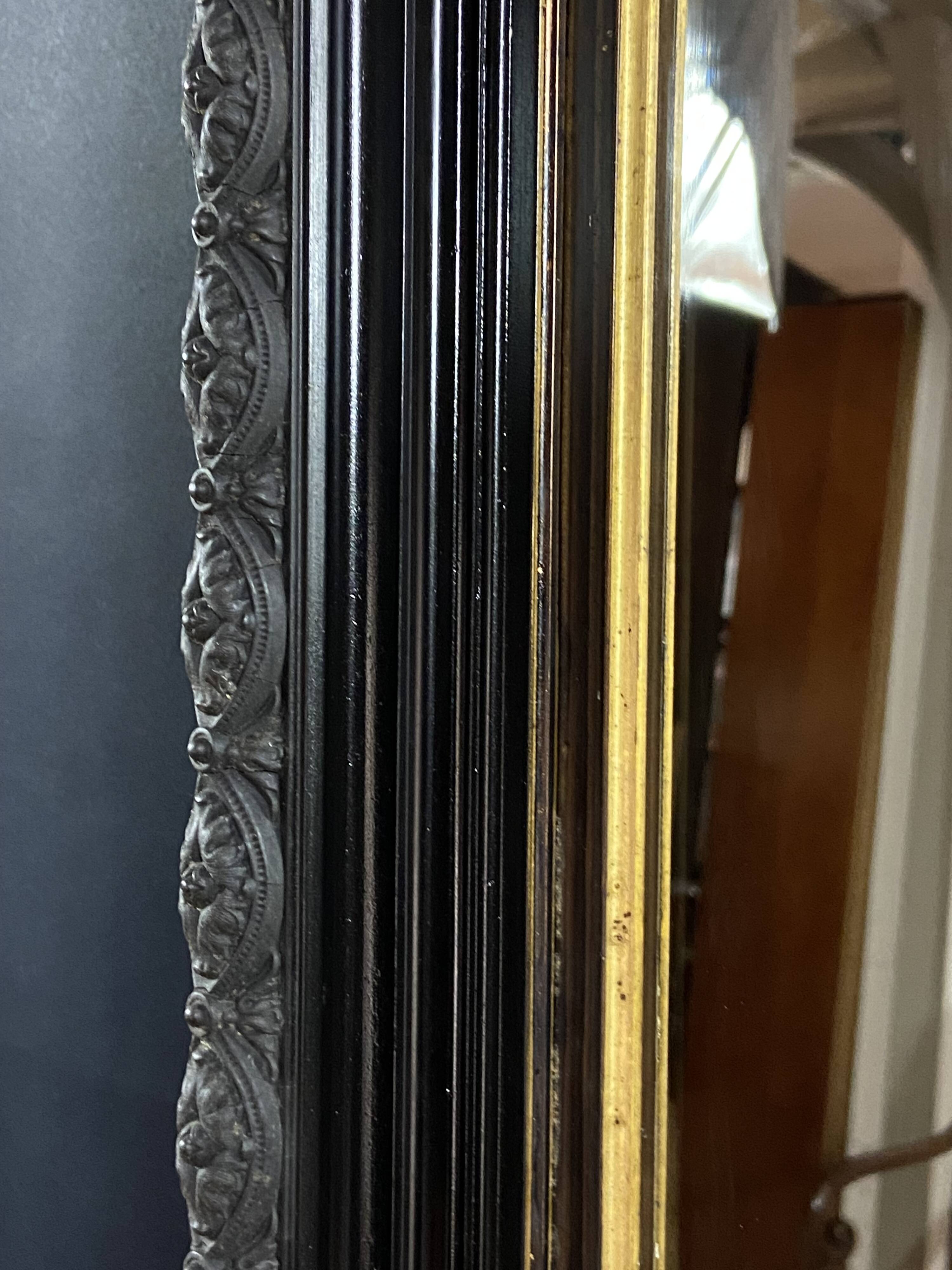 19th-century mirror Napoleon III in blackened wood on a gold background.