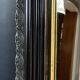 19th-century mirror Napoleon III in blackened wood on a gold background.