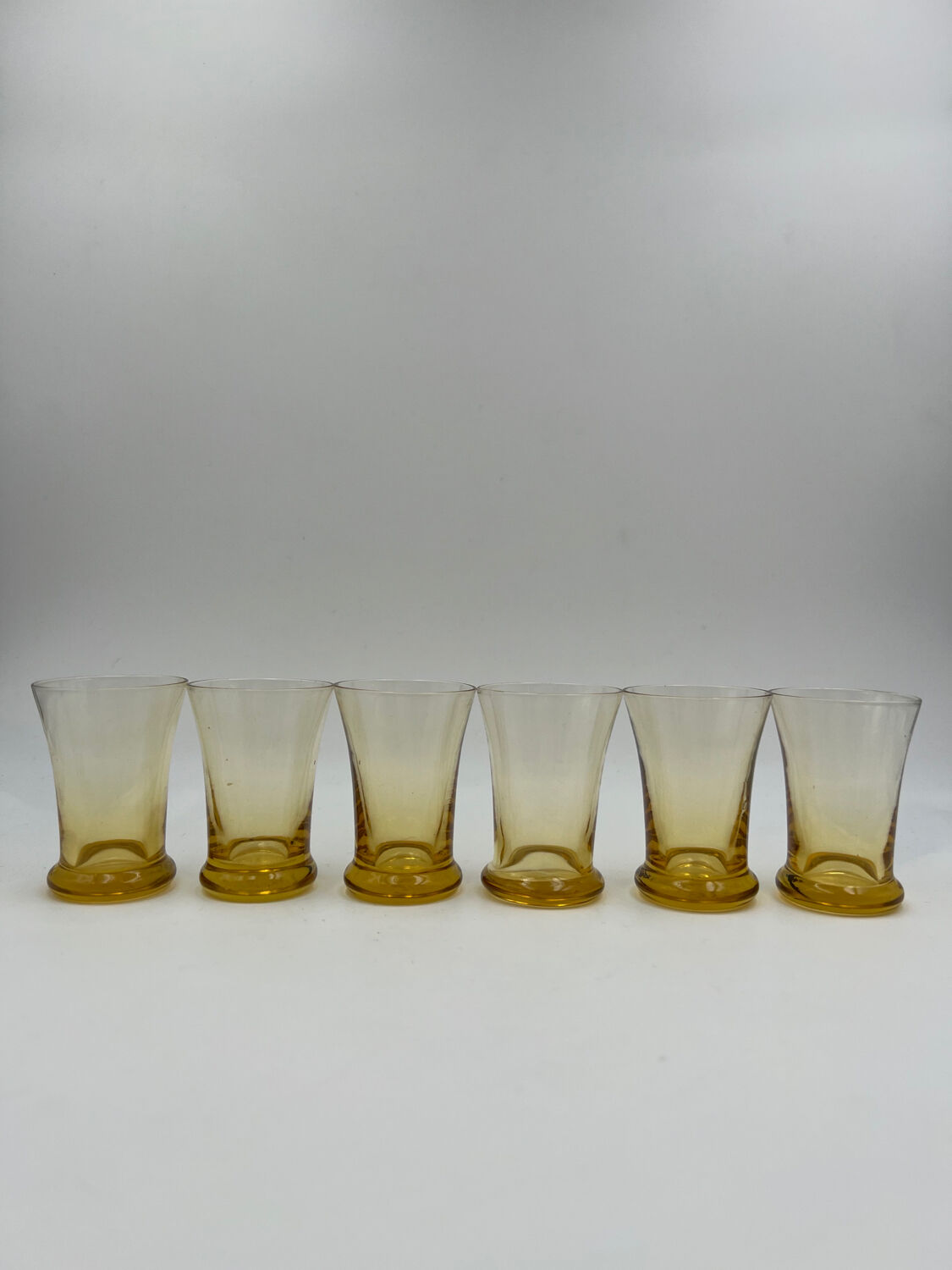 Six yellow glass shooting glasses