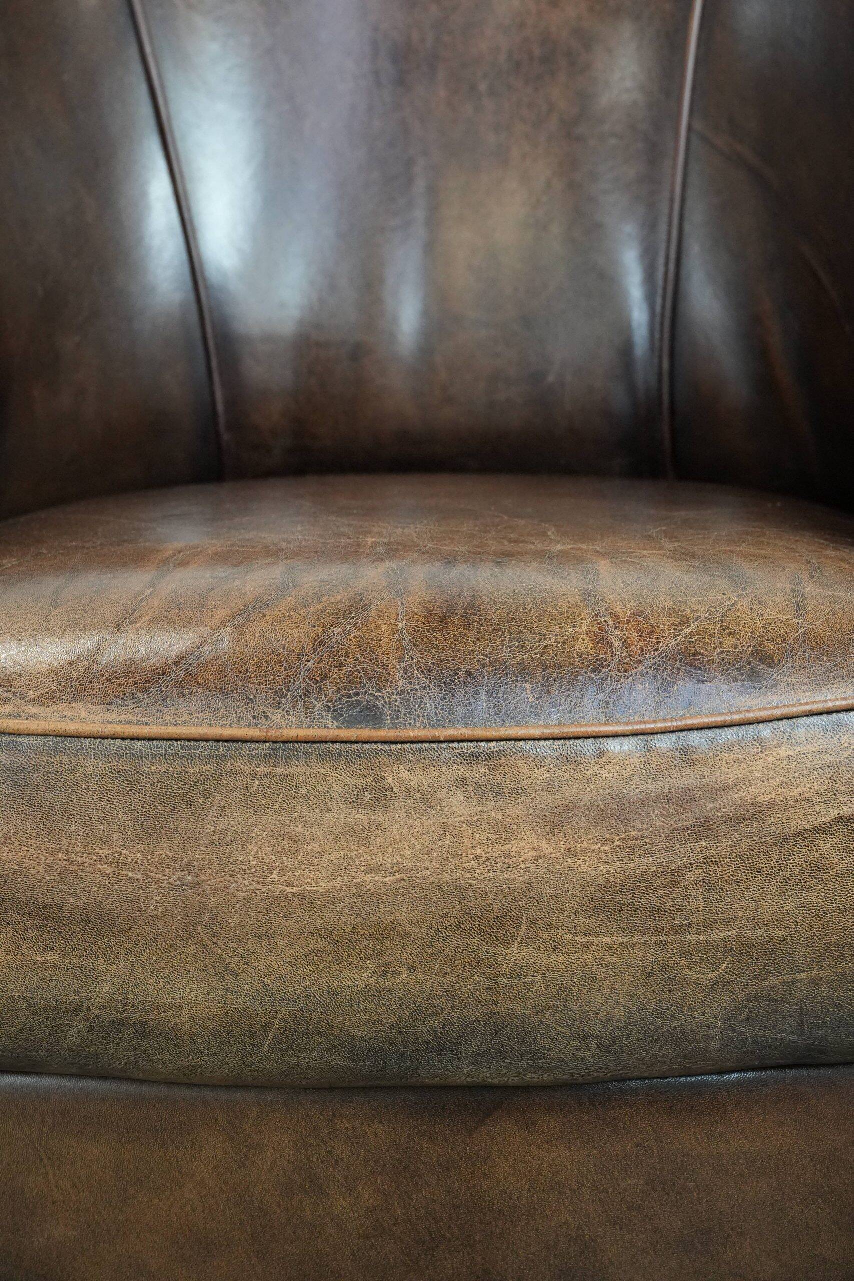 Set of two sheepskin club armchairs with fixed seat cushions