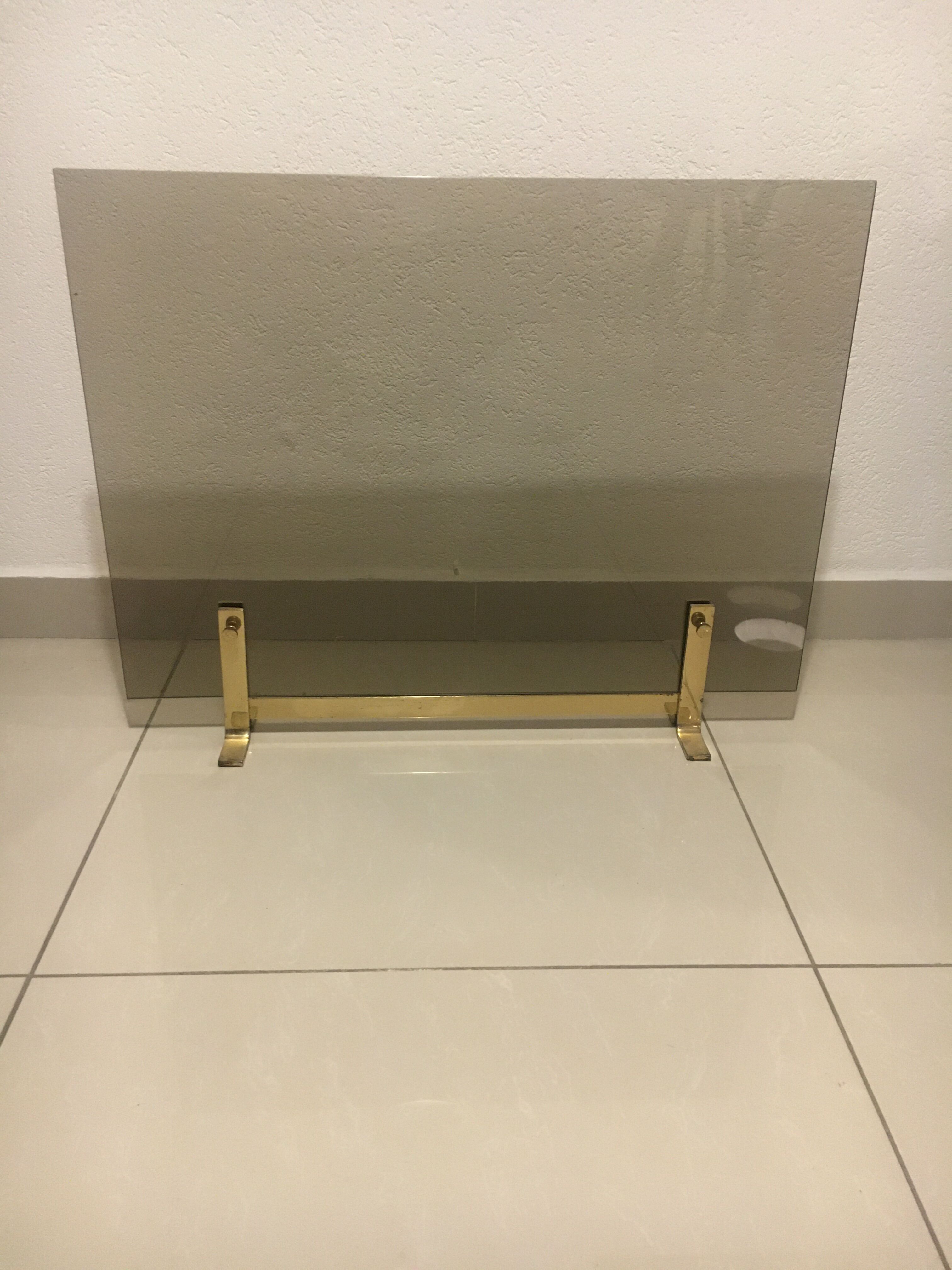 Fireplace screen in smoked glass and brass