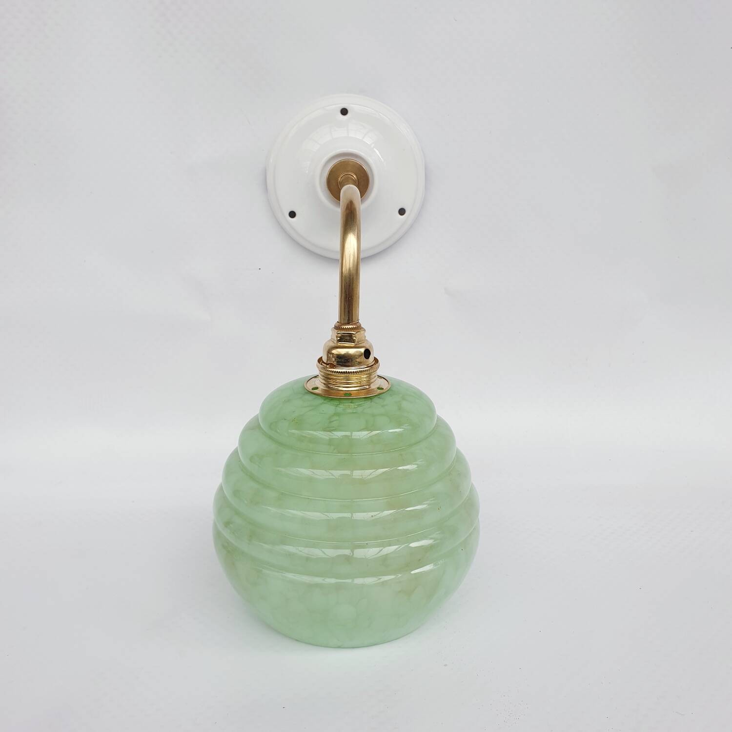 Brass collar and speckled glass wall lamp