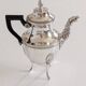 Empire-style silver-plated coffee pot with eagle head spout.