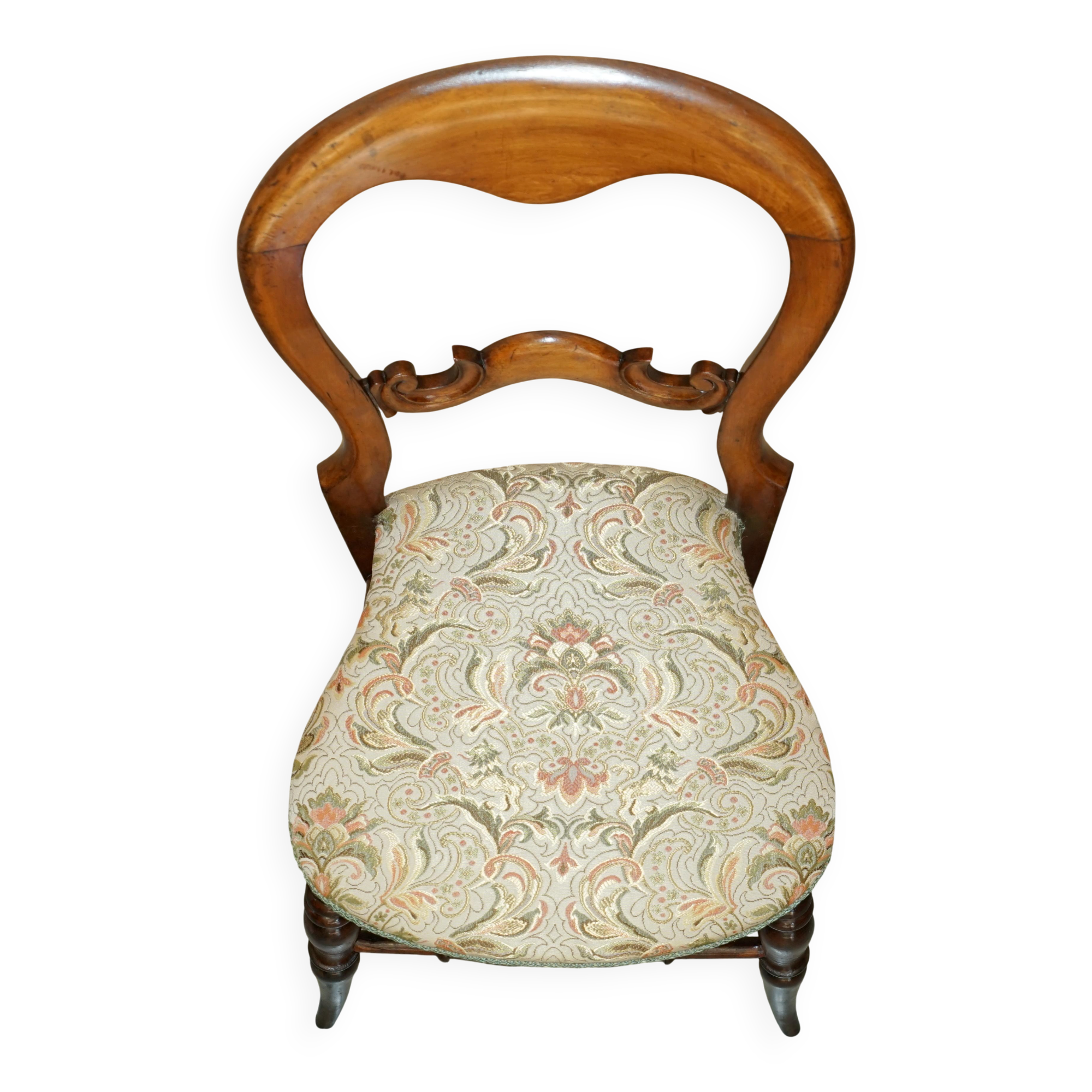 Victorian walnut dressing table chair from around 1880 with a medallion on the backrest.