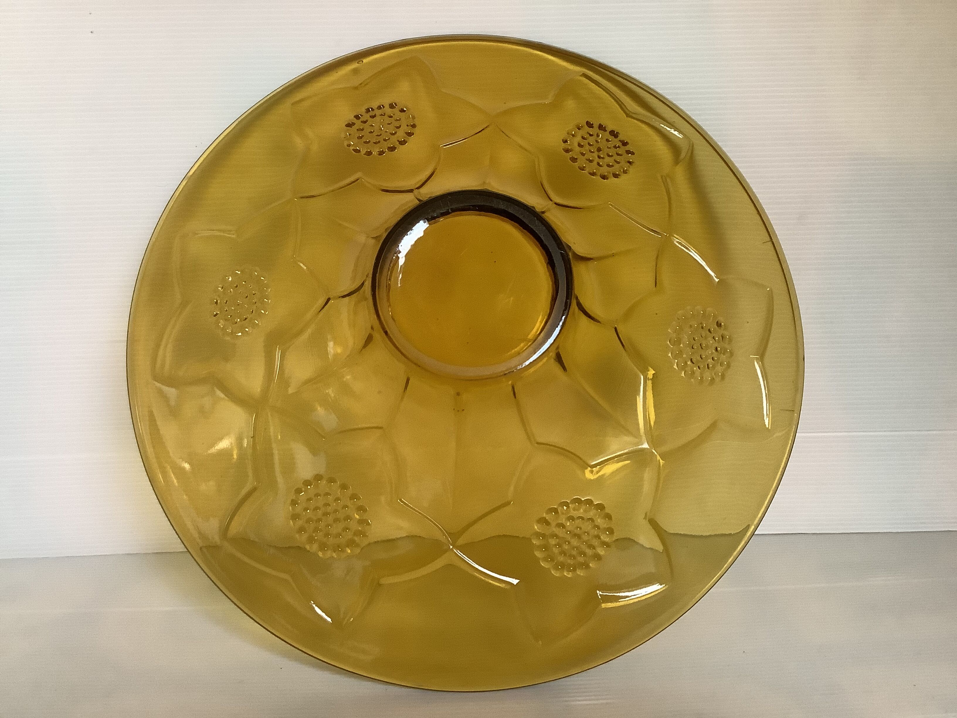 Yellow glass cup with a floral pattern