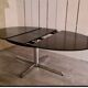 Blackened wooden dining table and chrome foot with integrated butterfly extension