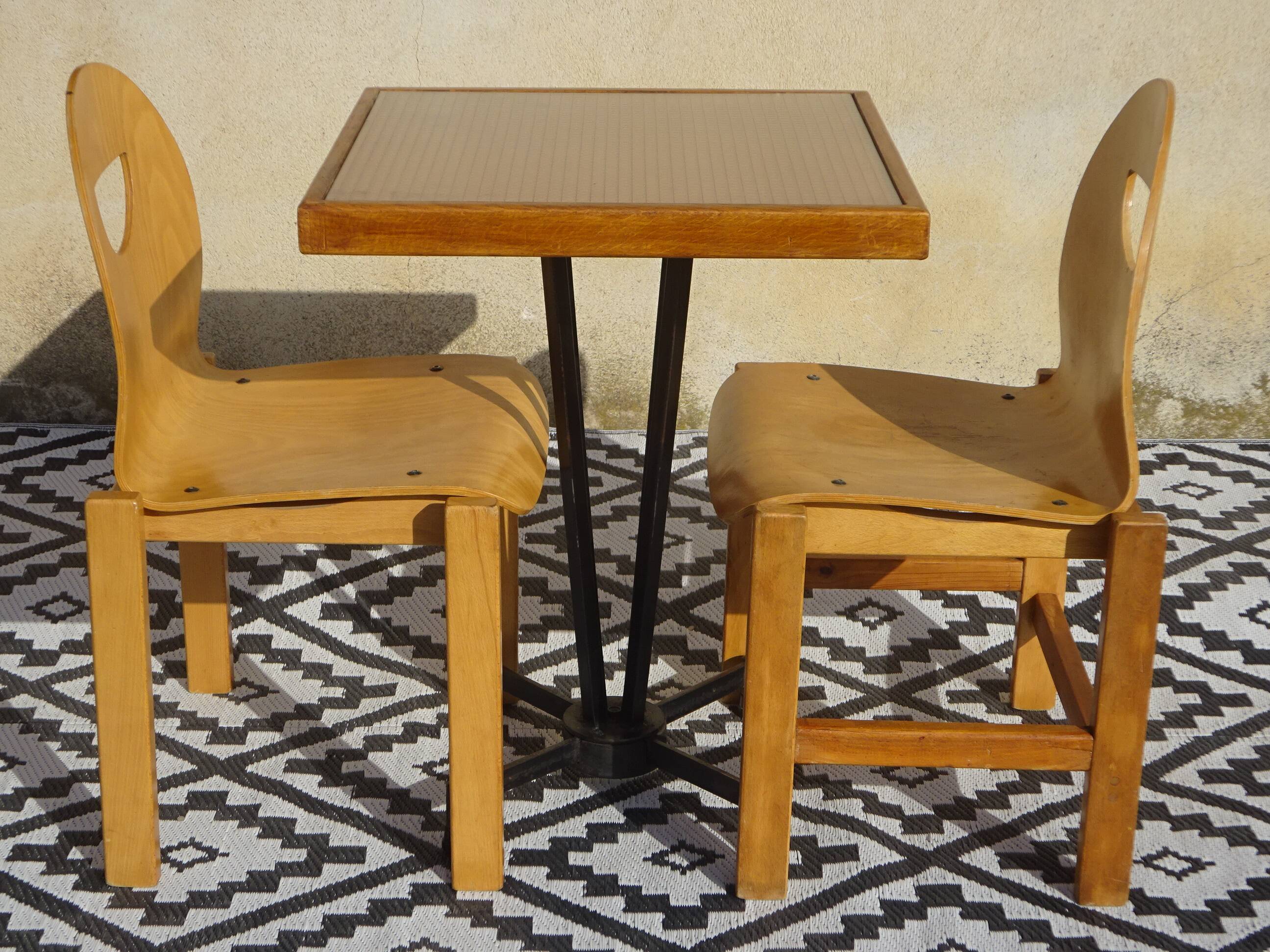Pair of light wood chairs with post-formed seat and backrest.