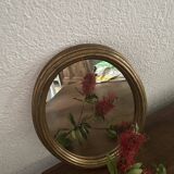 Classic oval mirror in gilded wood.