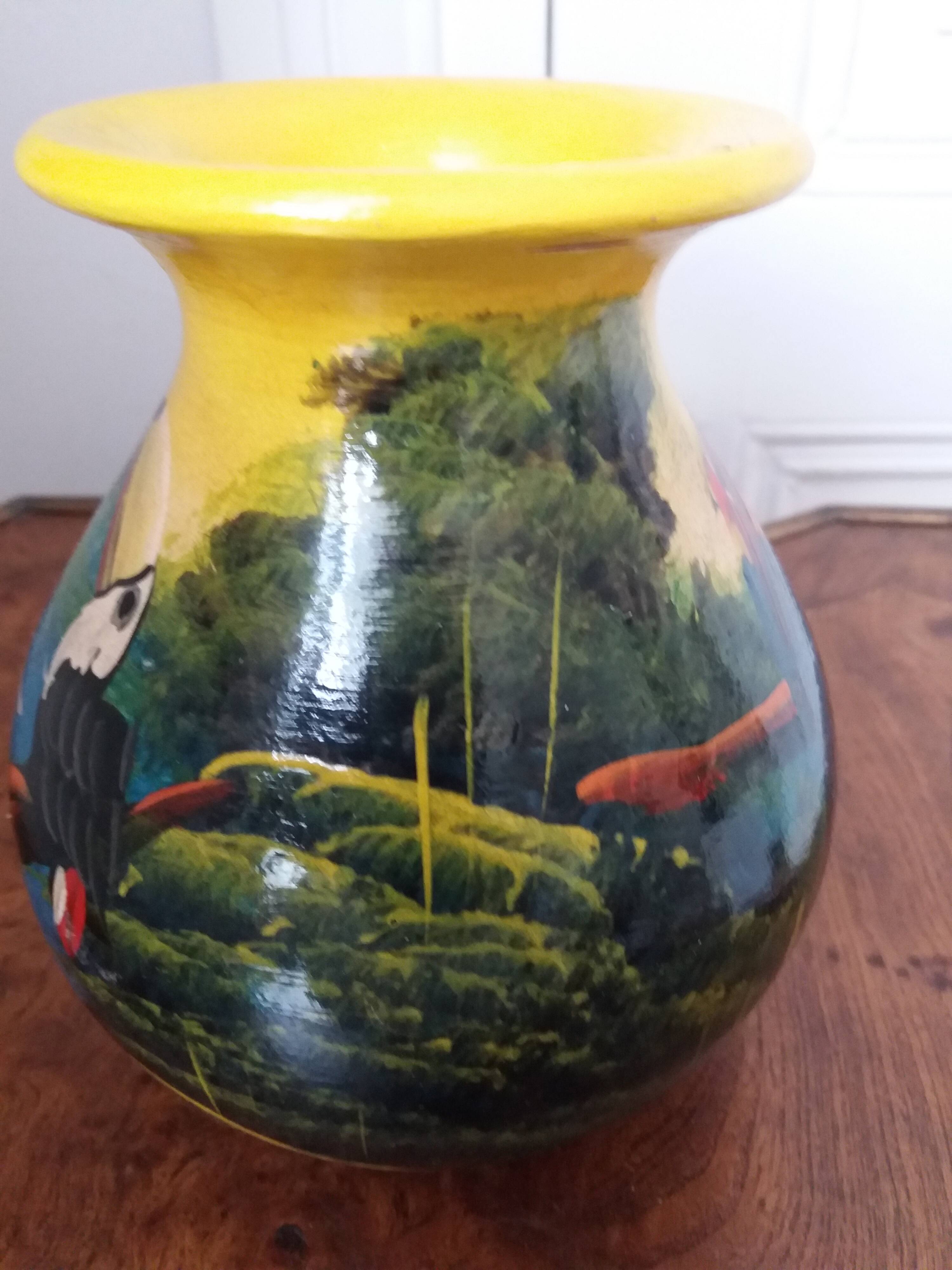 Mexican popular art vase decorated with parrots and toucans.