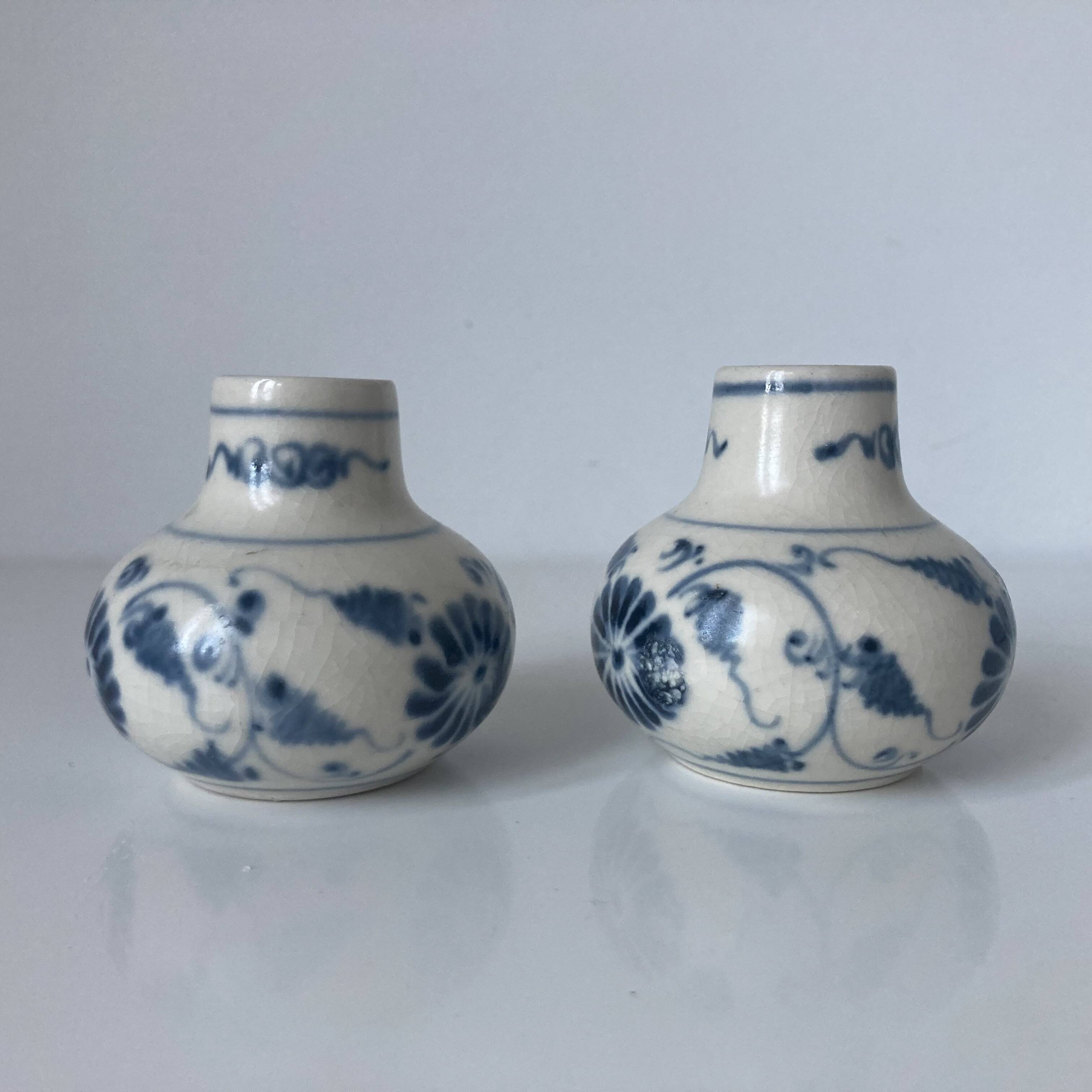 Pair of miniature blue and white Vietnamese ceramic vases with floral decoration.