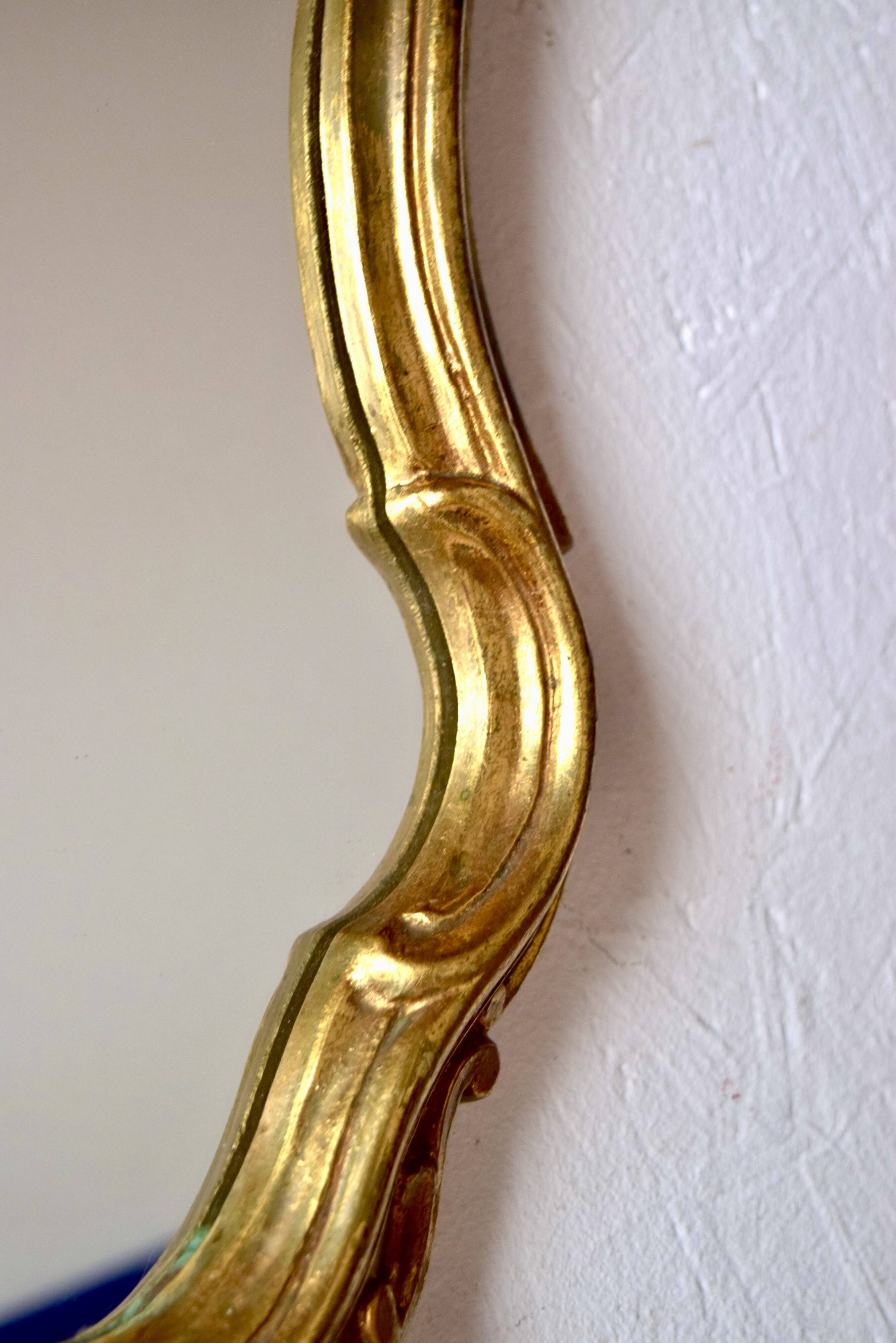 Large rococo mirror in gold painted wood
