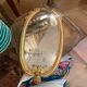 Oval mirror in gilded wood
