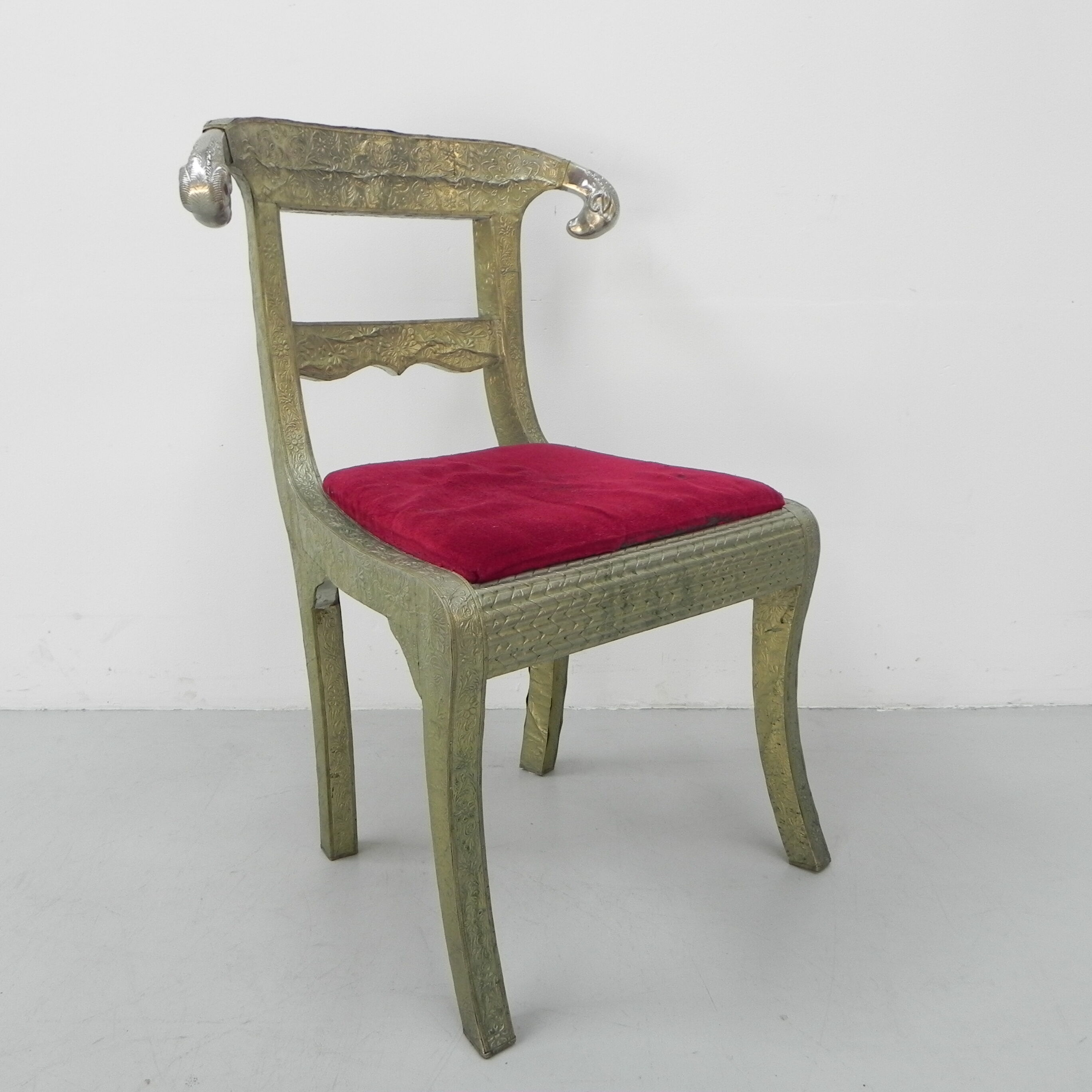 Dining chair upholstered with stamped tin