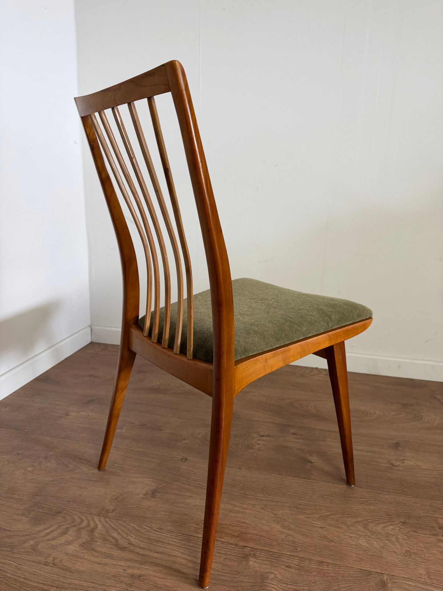 Scandinavian chairs with green velvet upholstery.