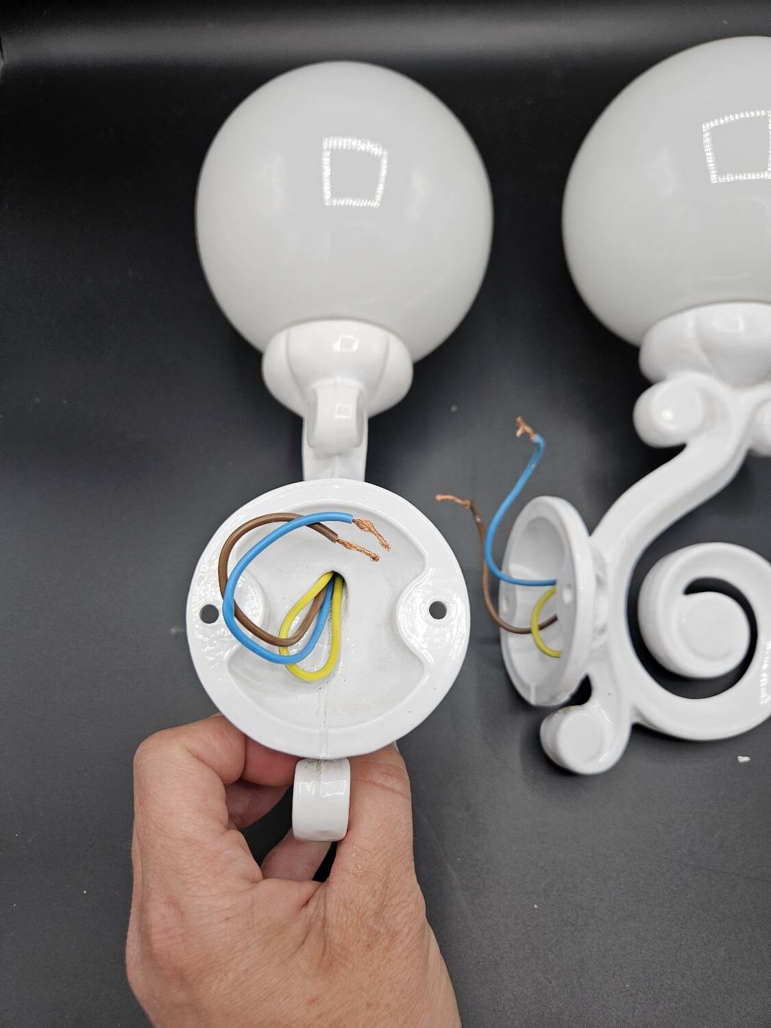 Pair of white enameled cast iron wall sconces, mid-20th century