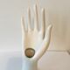 Hand soliflore wearing white ring