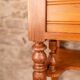 Antique washbasin cabinet in solid pitch pine with a white marble top.