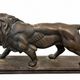 Bronze lion in motion with a brown patina, signed barye.