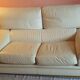 Two-seater convertible sofa bed in off-white leather by Ligne Roset.