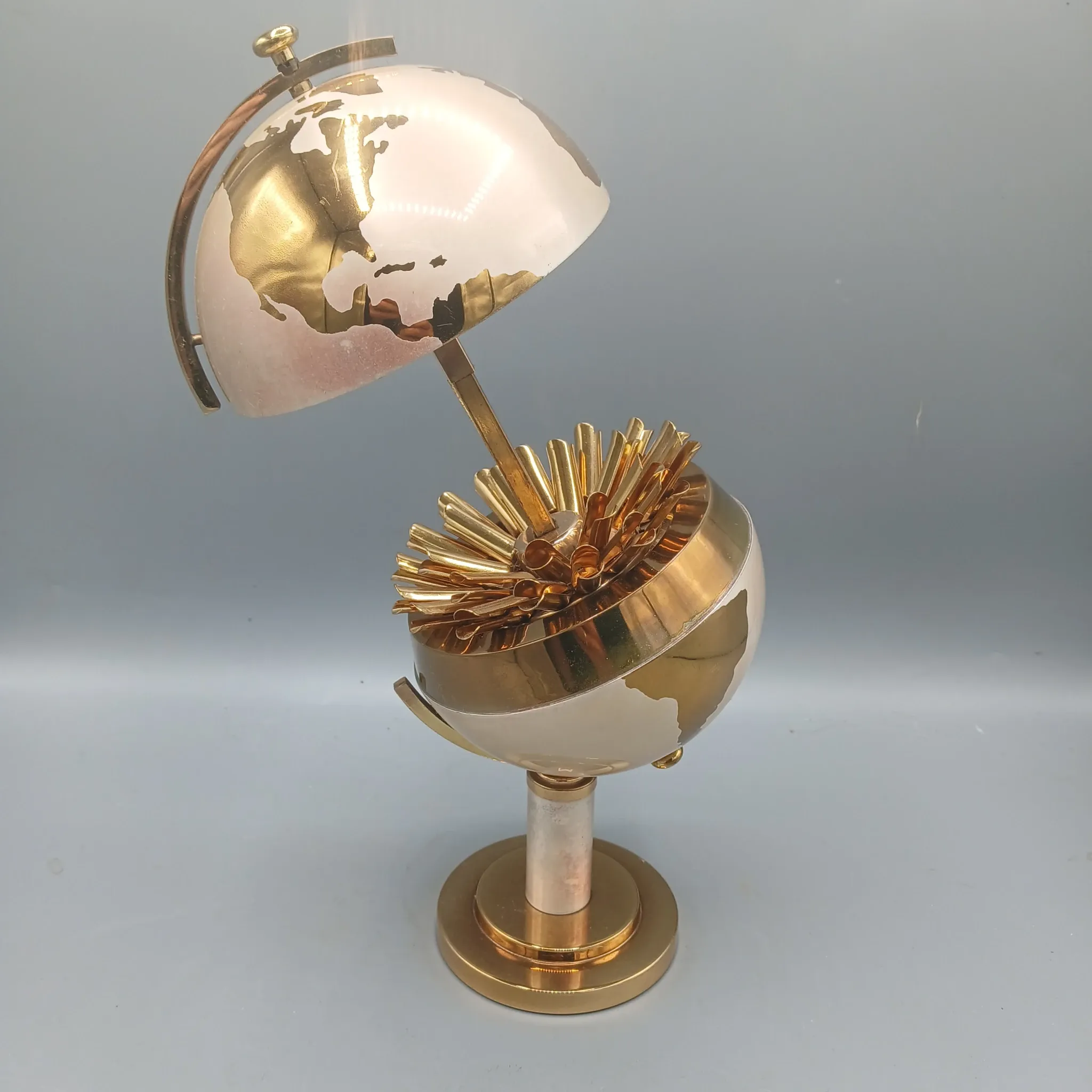 Vintage brass globe cigarette dispenser