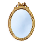 Antique oval mirror in gilded resin with Louis XVI style knot decoration