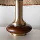 Lot of 2 vintage table lamps from the 1970s, dark wood oval bases with curved brass details, handmade natural fibre lampshades, elegant lighting.