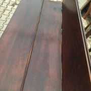 19th-century brown walnut dining table with sculpted trestle legs.