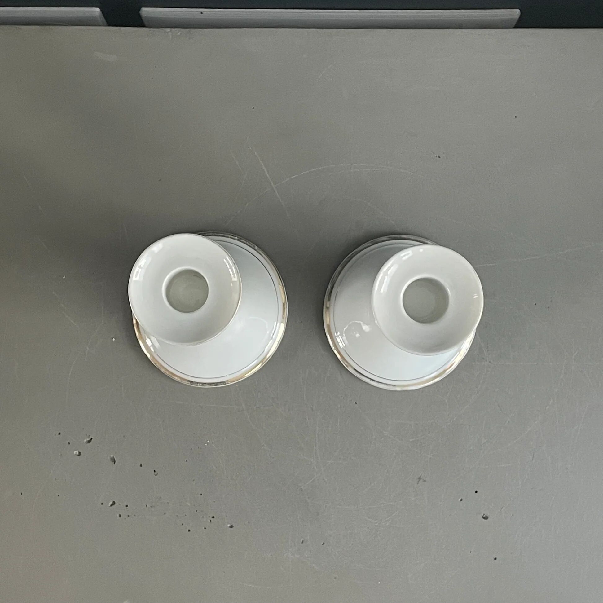 Pair of porcelain candlesticks with a gold pattern.