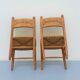 Pair of wooden chairs with seat and straw back