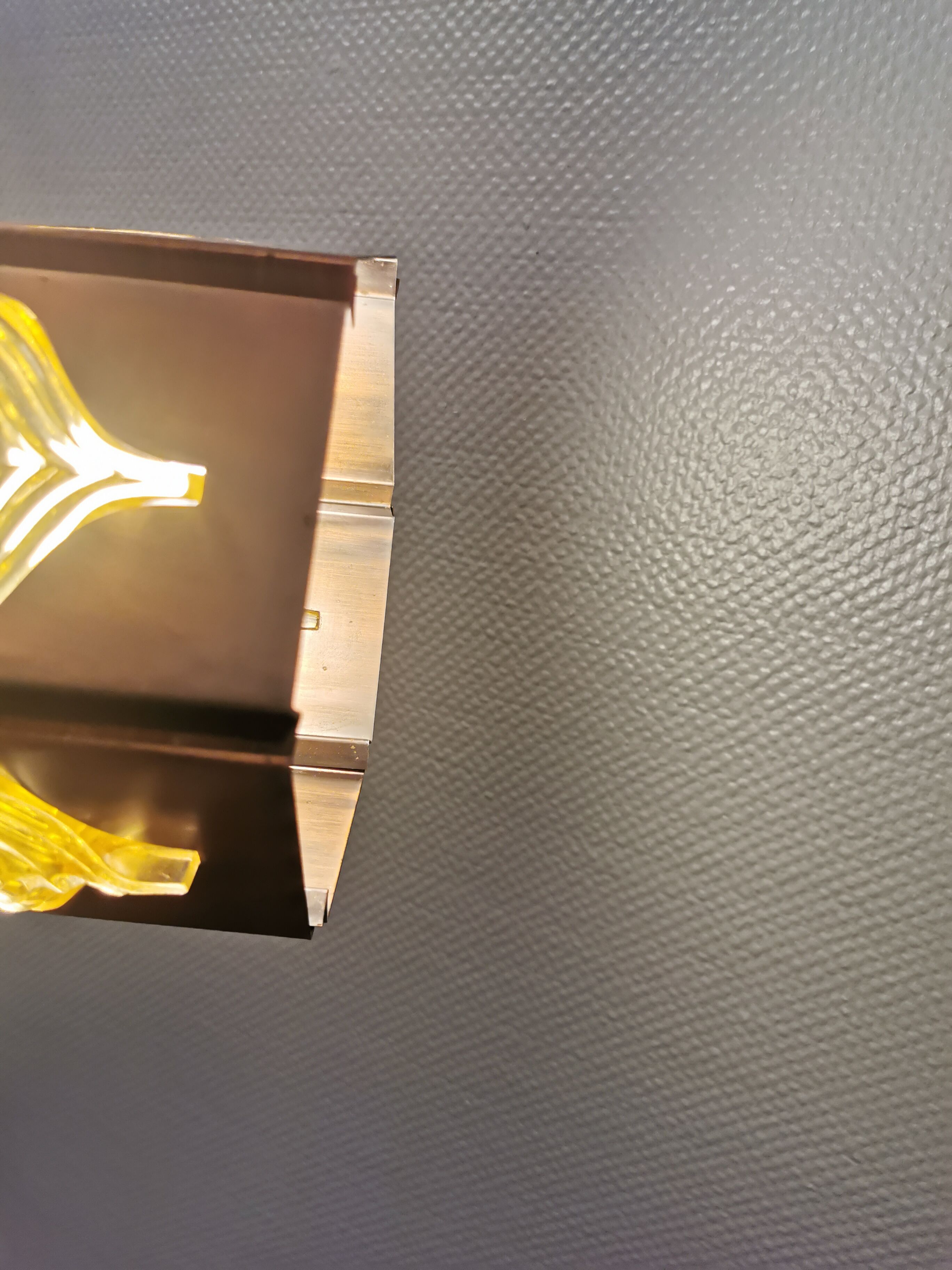 Older hanging lamp, made of metal with yellow prisms.