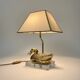 Vintage brass table lamp in the shape of a duck from the 1970s on an acrylic base.