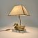 Vintage brass table lamp in the shape of a duck from the 1970s on an acrylic base.