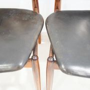 Set of four Arne Vodder chairs in hardwood and black leather.