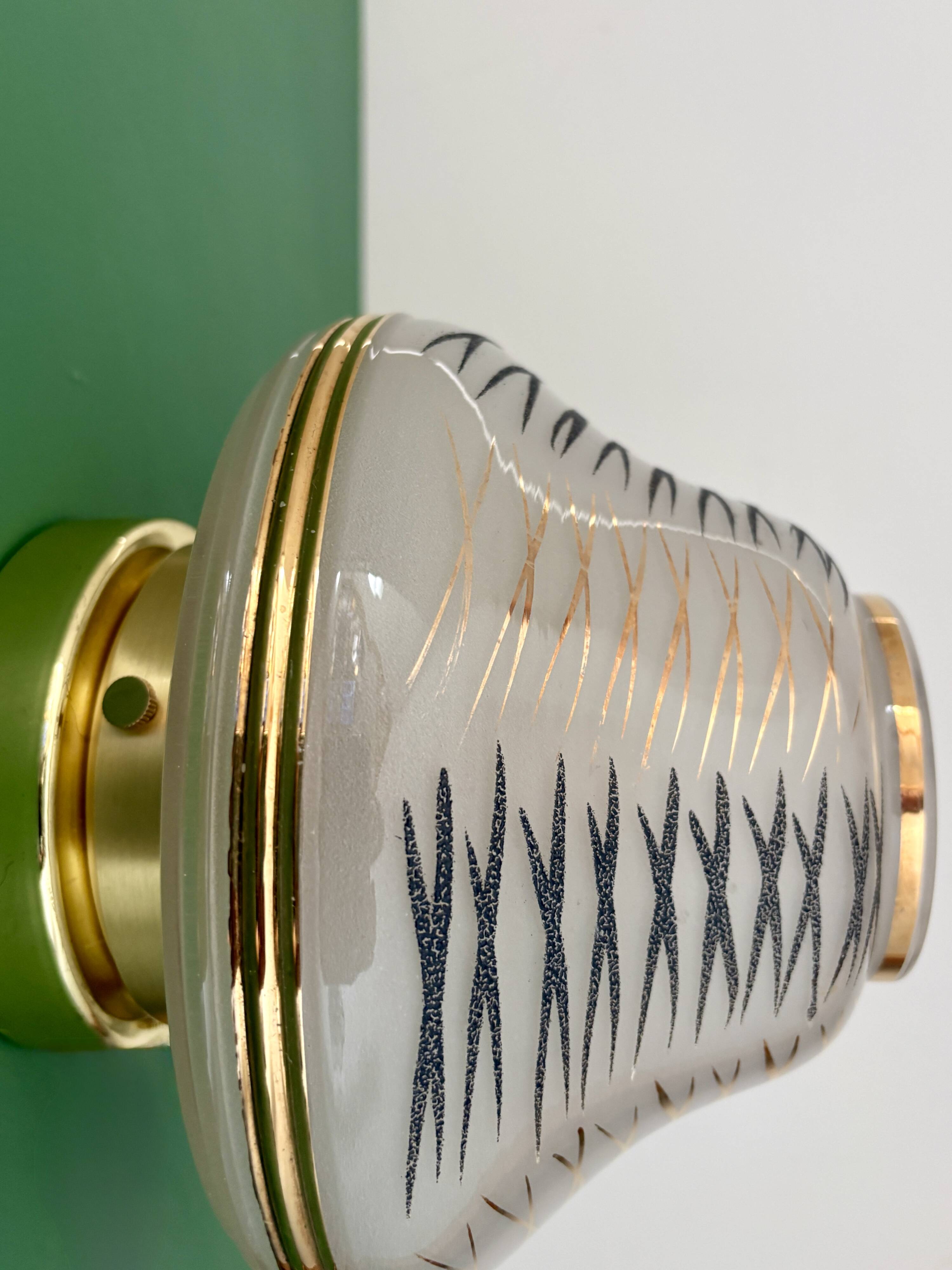 Vintage Art Deco globe wall/ceiling light in white, black, and gold glass.