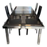 Vintage Roche Bobois dining table with smoked glass and 4 leather chairs.