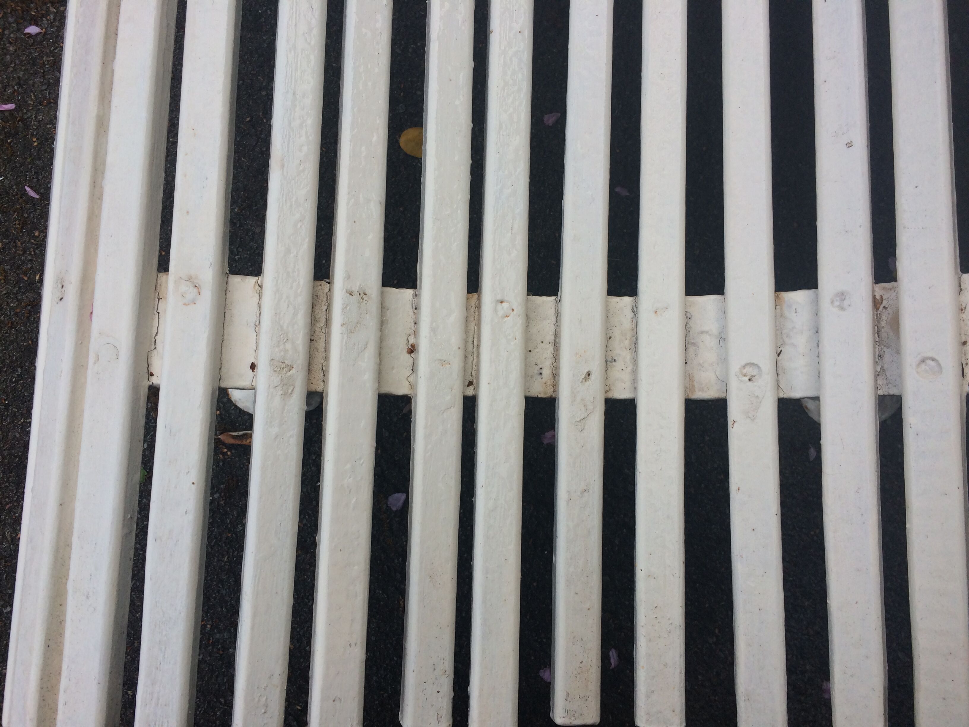 Old garden bench, cast iron feet and white wooden slats