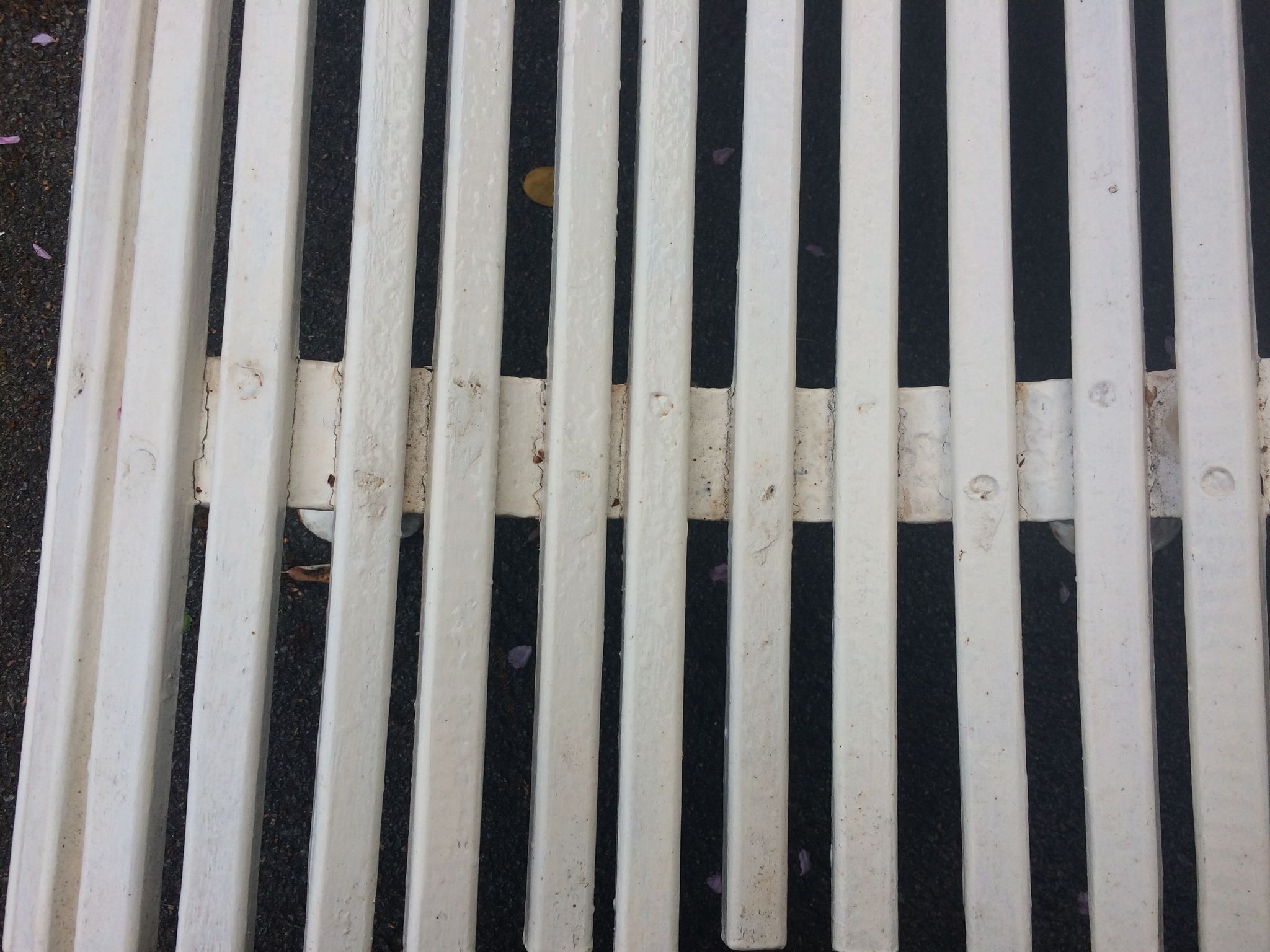 Old garden bench, cast iron feet and white wooden slats
