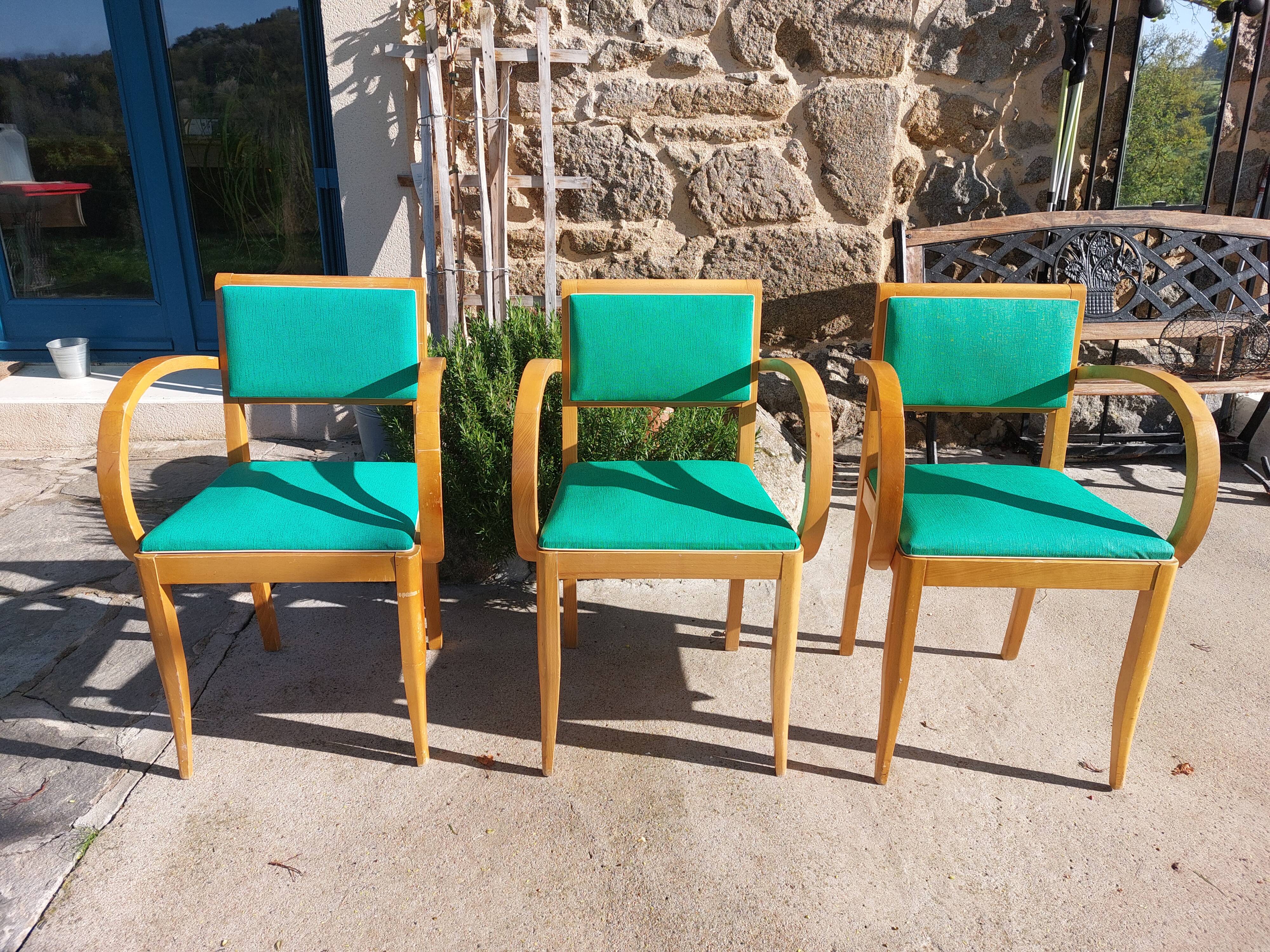 3 vintage bridge chairs with rounded armrests.