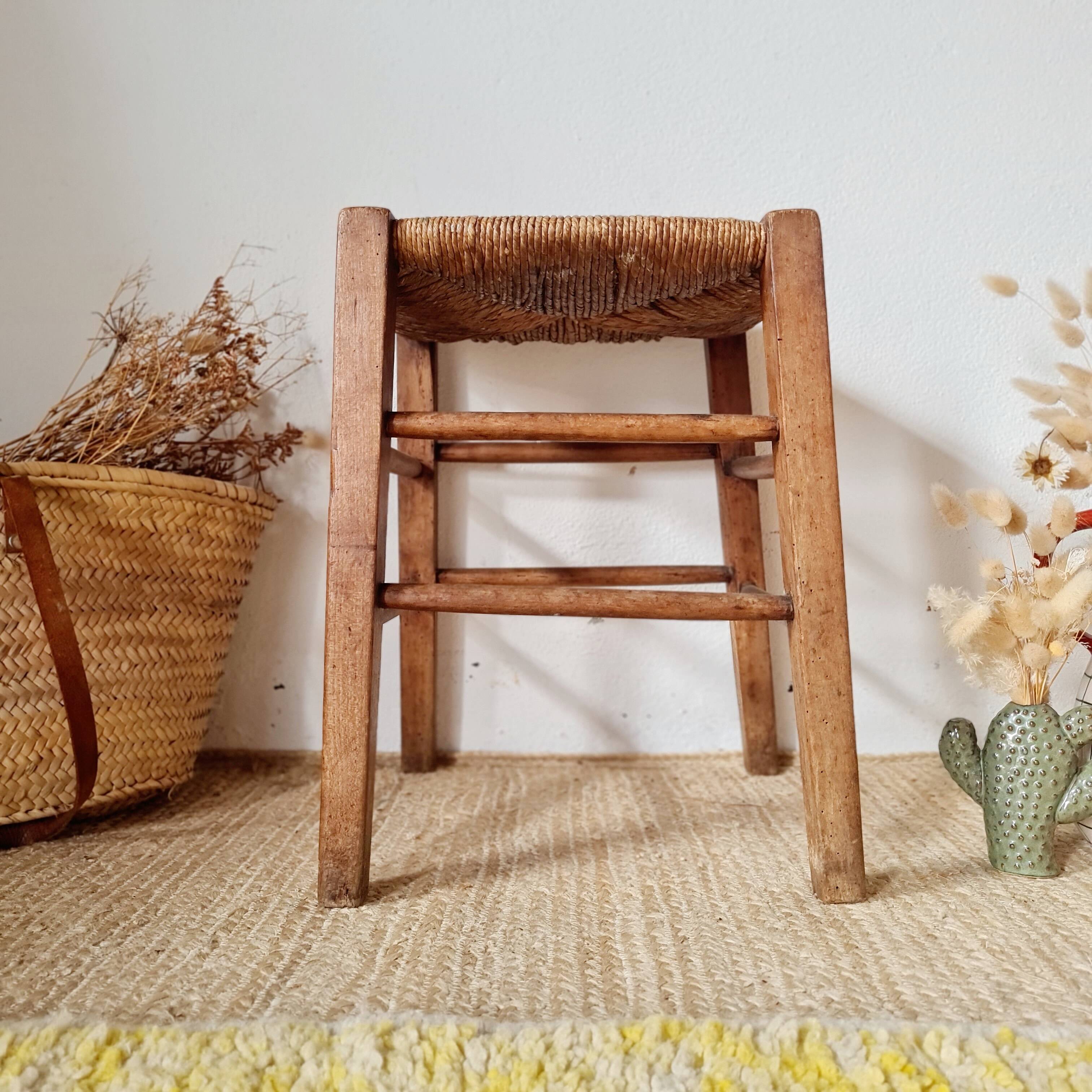 Old farmhouse stool made of wood and straw