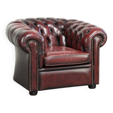 Chic lived-in English chesterfield club armchair in a timeless red colour